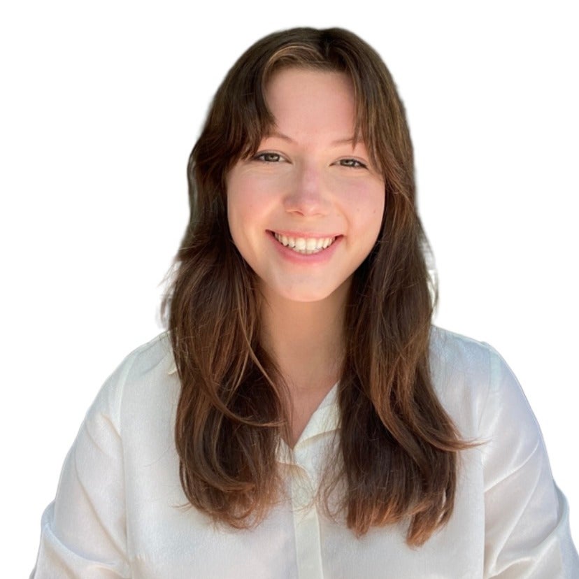 Connie Moore's headshot. A person with long hair and side bangs wearing a collared shirt smiles at the camera.